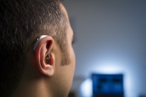 International experts to discuss ways of reducing hearing loss risks of living in a noisy world - pic - man with hearing aid